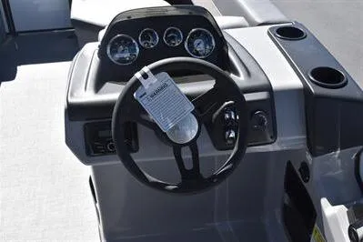 Slide: The Image of 2025 Lowe LS 170 boat dashboard with steering wheel and instrument panel. - 25