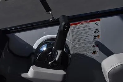 Slide: The Image of Control panel of 2025 Lowe LS 170 boat with throttle lever and safety instructions. - 30