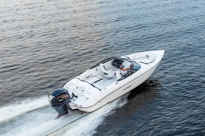 Slide: The Image of 2026 Stingray 23 OSX boat cruising on calm water. - 14