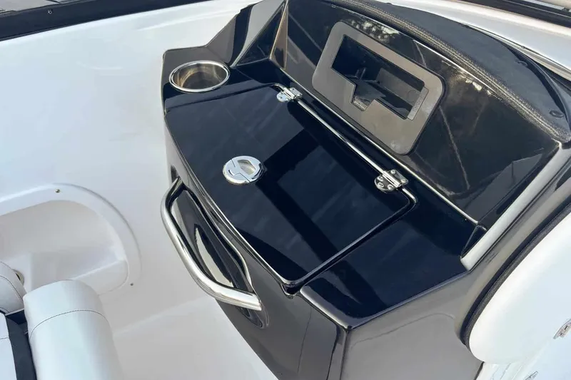 Slide: The Image of Interior view of 2026 Stingray 23 OSX boat with black dashboard. - 8