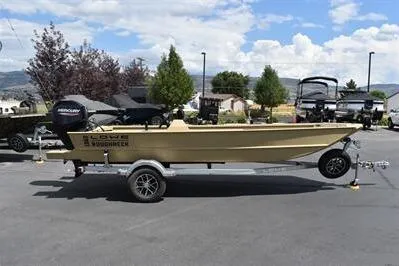 The Image of 2025 Lowe Roughneck 1860 boat on trailer, parked outdoors under a cloudy sky. - 0