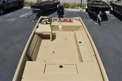 Slide: The Image of 2025 Lowe Roughneck 1860 boat, beige deck, parked outdoors, featuring spacious layout. - 10