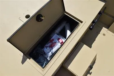 Slide: The Image of Open storage compartment on 2025 Lowe Roughneck 1860 boat, showing interior contents. - 11