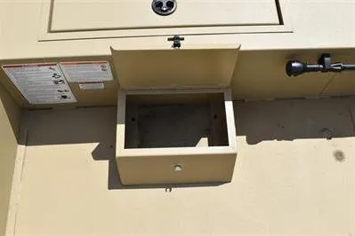 Slide: The Image of 2025 Lowe Roughneck 1860 boat storage compartment, beige interior, open lid. - 12