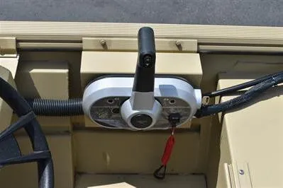 Slide: The Image of Control panel of 2025 Lowe Roughneck 1860 boat with steering wheel and throttle lever. - 15