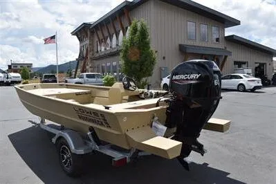 Slide: The Image of 2025 Lowe Roughneck 1860 boat with Mercury engine on trailer, parked outside a building. - 3