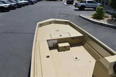 Slide: The Image of 2025 Lowe Roughneck 1860 boat with spacious deck, parked outdoors. - 9