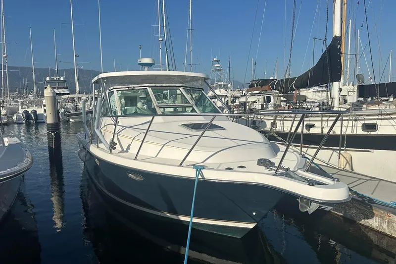 The Image of 2005 Tiara 2900 Open boat docked in a marina, surrounded by other vessels. - 0