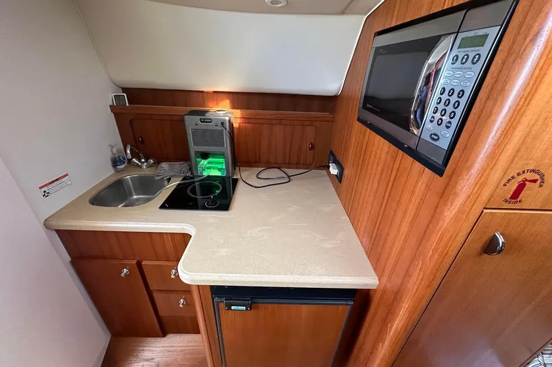 Slide: The Image of Compact kitchen in a 2005 Tiara 2900 Open boat with microwave and sink. - 12