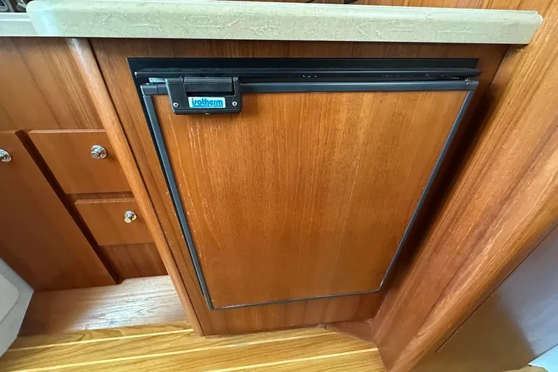 Slide: The Image of Wooden cabinet with Isotherm fridge in 2005 Tiara 2900 Open boat interior. - 13