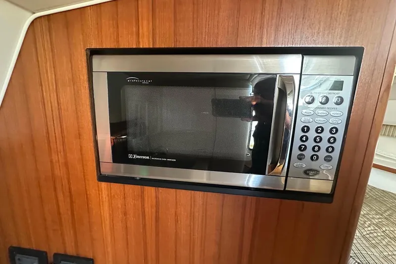 Slide: The Image of Built-in Emerson microwave in 2005 Tiara 2900 Open boat interior. - 14