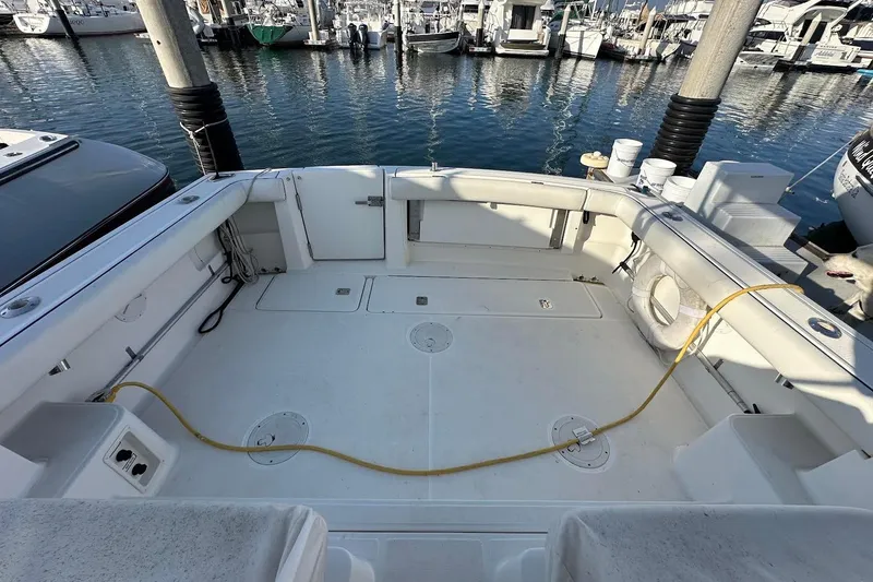 Slide: The Image of 2005 Tiara 2900 Open boat deck at marina, featuring spacious layout and clean design. - 2