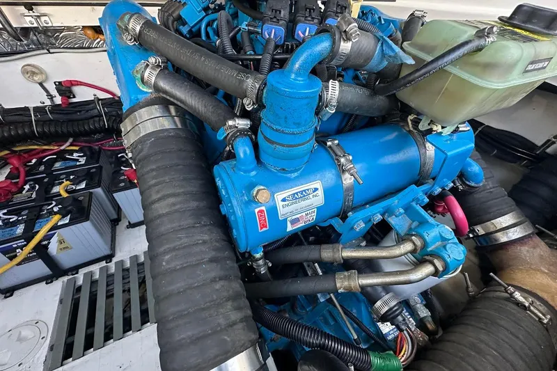 Slide: The Image of Engine compartment of a 2005 Tiara 2900 Open boat, featuring blue machinery and battery setup. - 21