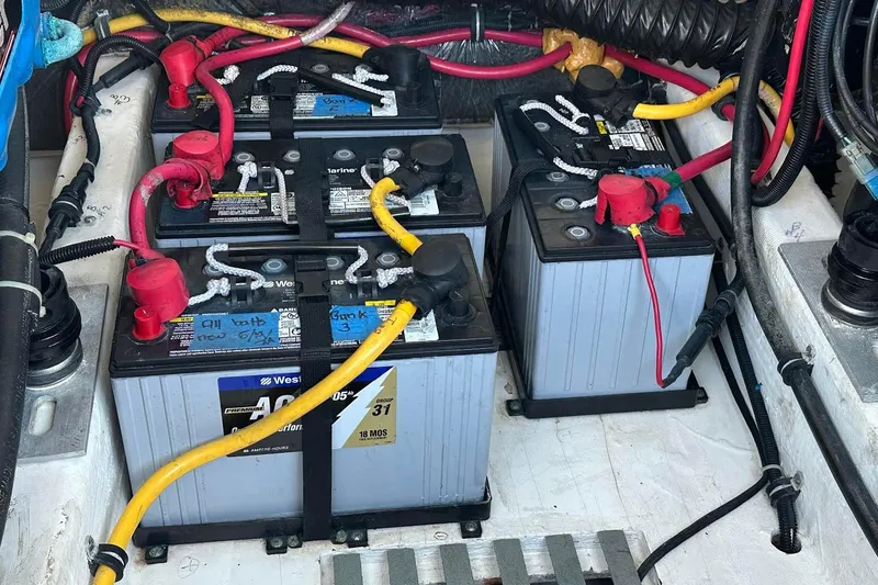 Slide: The Image of Battery compartment of a 2005 Tiara 2900 Open boat with connected cables. - 22