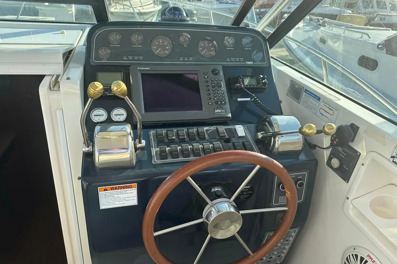 Slide: The Image of Helm of 2005 Tiara 2900 Open boat with steering wheel and control panel. - 3