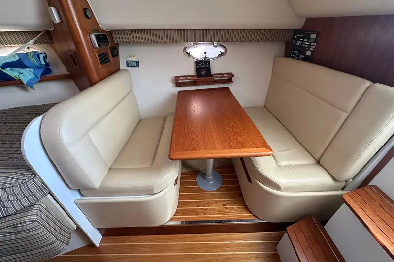 Slide: The Image of Interior of a 2005 Tiara 2900 Open boat with beige seating and wooden table. - 7