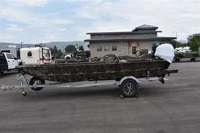 The Image of 2025 Lowe Roughneck 1860 Rambler boat on trailer, parked outdoors. - 0