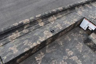 Slide: The Image of 2025 Lowe Roughneck 1860 Rambler boat with camouflage pattern and storage compartment. - 10