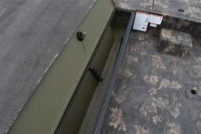 Slide: The Image of 2025 Lowe Roughneck 1860 Rambler boat interior with camouflage design and storage compartment. - 11