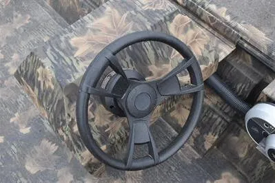 Slide: The Image of Steering wheel of 2025 Lowe Roughneck 1860 Rambler boat with camouflage design. - 13
