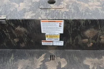 Slide: The Image of 2025 Lowe Roughneck 1860 Rambler boat with camouflage pattern and safety labels. - 15