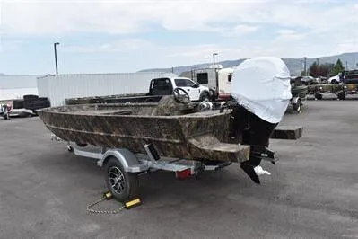 Slide: The Image of 2025 Lowe Roughneck 1860 Rambler boat on trailer, camo design, parked outdoors. - 5
