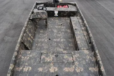 Slide: The Image of 2025 Lowe Roughneck 1860 Rambler boat with camouflage design, spacious interior, and steering console. - 7