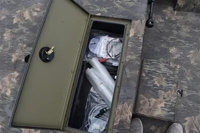 Slide: The Image of Storage compartment of 2025 Lowe Roughneck 1860 Rambler boat, showcasing organized gear and equipment. - 8