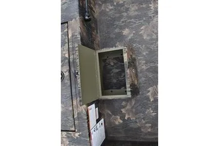 Slide: The Image of 2025 Lowe Roughneck 1860 Rambler interior with open storage compartment, camo design. - 9