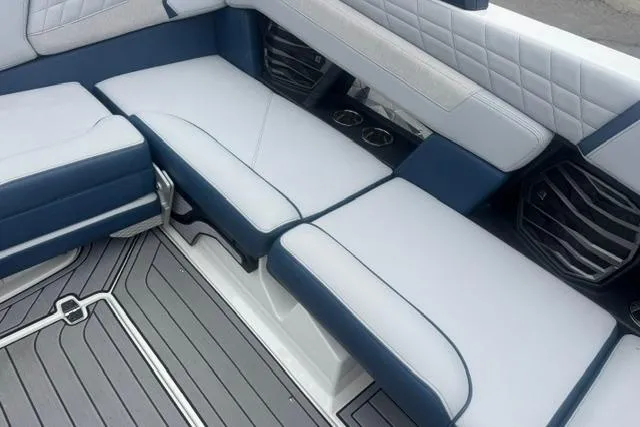 Slide: The Image of 2022 Nautique Super Air Nautique G21 interior seating with blue and white upholstery. - 17