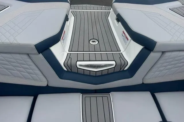 Slide: The Image of 2022 Nautique Super Air Nautique G21 boat interior with sleek, modern seating and deck design. - 18