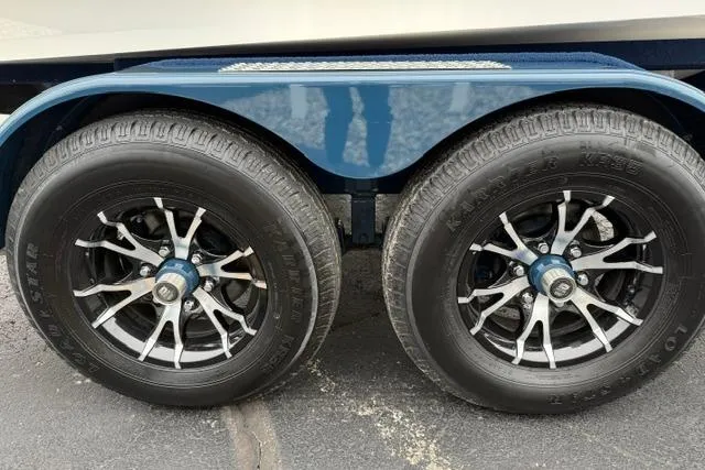 Slide: The Image of Trailer wheels of 2022 Nautique Super Air Nautique G21, featuring stylish rims. - 25