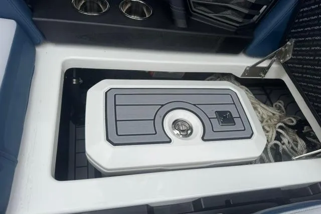 Slide: The Image of Storage compartment in 2022 Nautique Super Air Nautique G21 boat, featuring cup holders and ropes. - 29