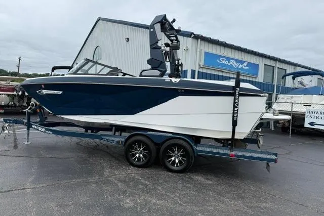 Slide: The Image of 2022 Nautique Super Air Nautique G21 boat on trailer outside showroom. - 3