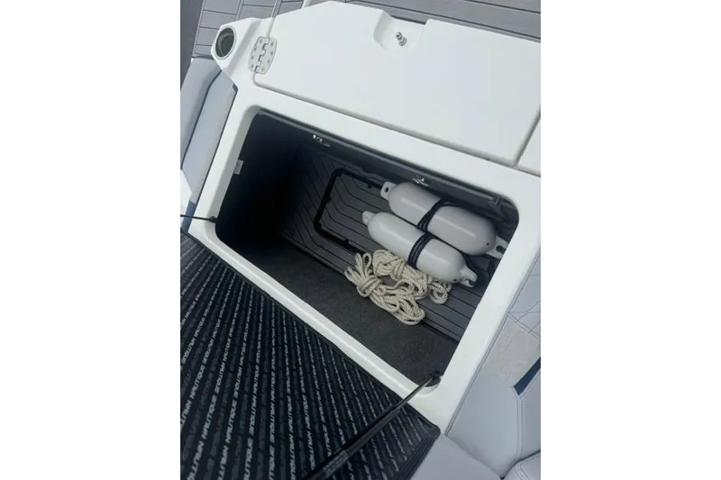 Slide: The Image of Storage compartment in 2022 Nautique Super Air Nautique G21 with ropes and fenders. - 30