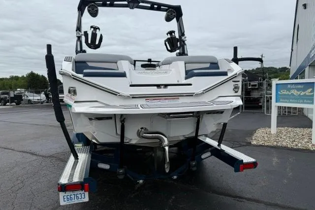 Slide: The Image of 2022 Nautique Super Air Nautique G21 boat on trailer, rear view, parked outdoors. - 4