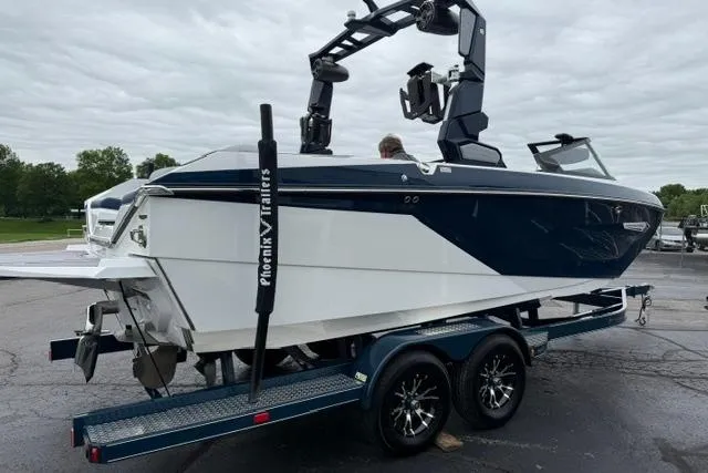Slide: The Image of 2022 Nautique Super Air Nautique G21 boat on trailer, parked outdoors. - 6