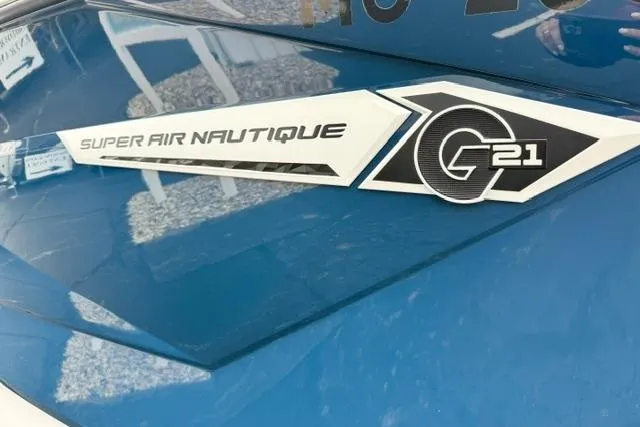 Slide: The Image of 2022 Nautique Super Air Nautique G21 logo on blue boat surface. - 9