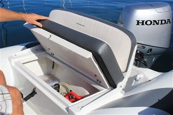 Slide: The Image of 2023 Walker Bay 365 STX boat with open storage compartment and Honda motor. - 11