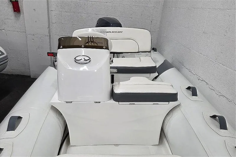 Slide: The Image of 2023 Walker Bay 365 STX inflatable boat interior with seating and console. - 9