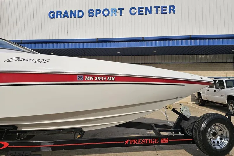 Slide: The Image of 2004 Baja 275 boat on trailer at Grand Sport Center, featuring sleek design and red accents. - 10