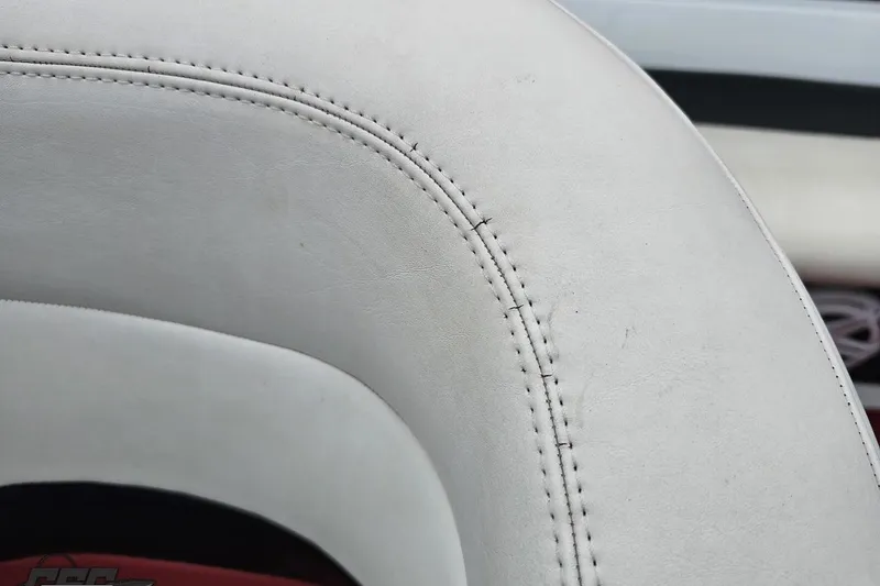 Slide: The Image of Close-up of white leather upholstery in a 2004 Baja 275 boat. - 101