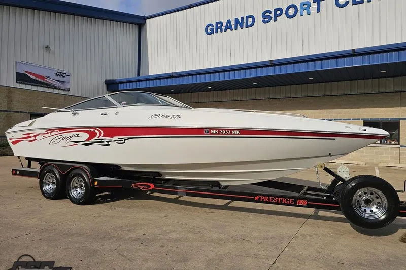 Slide: The Image of 2004 Baja 275 boat on trailer at Grand Sport Center, featuring sleek design and red accents. - 11
