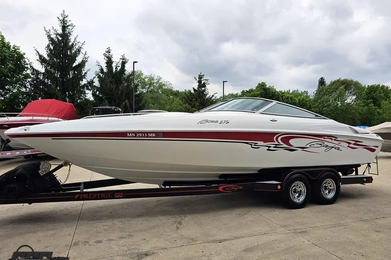 Slide: The Image of 2004 Baja 275 boat on trailer, white with red graphics, parked outdoors. - 15