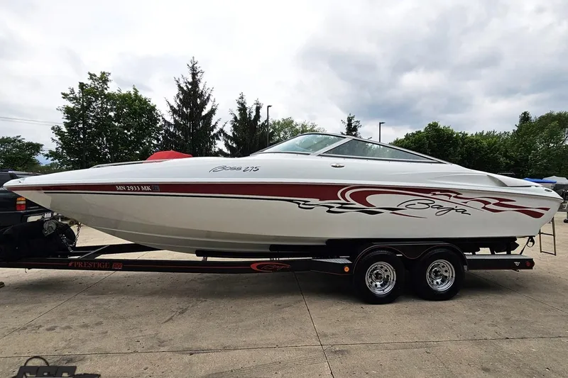 Slide: The Image of 2004 Baja 275 boat on trailer, featuring sleek design and red graphics. - 16