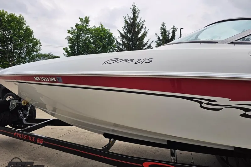 Slide: The Image of 2004 Baja 275 boat on trailer, featuring sleek design and red accents. - 17