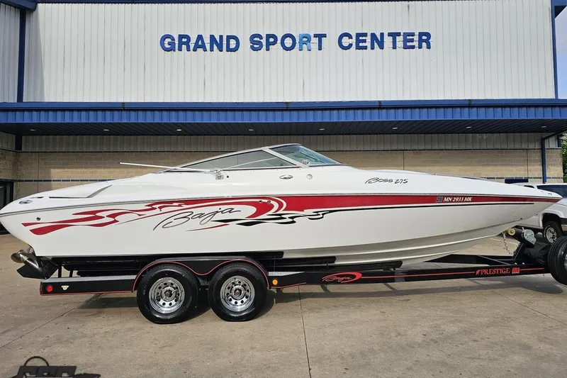 Slide: The Image of 2004 Baja 275 boat with red graphics on trailer at Grand Sport Center. - 2