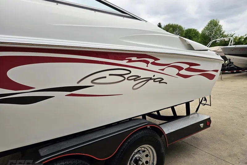 Slide: The Image of 2004 Baja 275 boat with red and black graphics on a trailer. - 20