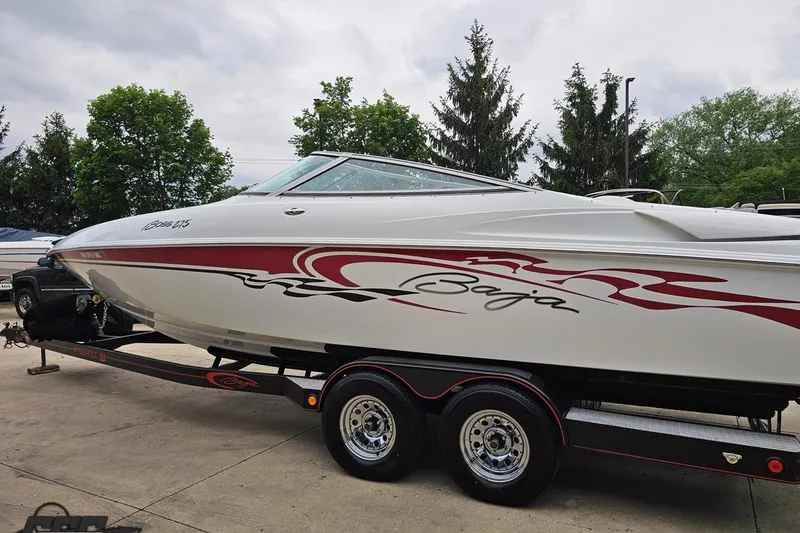 Slide: The Image of 2004 Baja 275 speedboat on trailer, featuring sleek design and red graphics. - 22