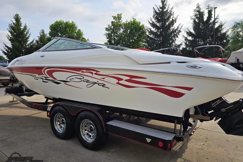 Slide: The Image of 2004 Baja 275 speedboat on trailer, featuring sleek design and red graphics. - 23